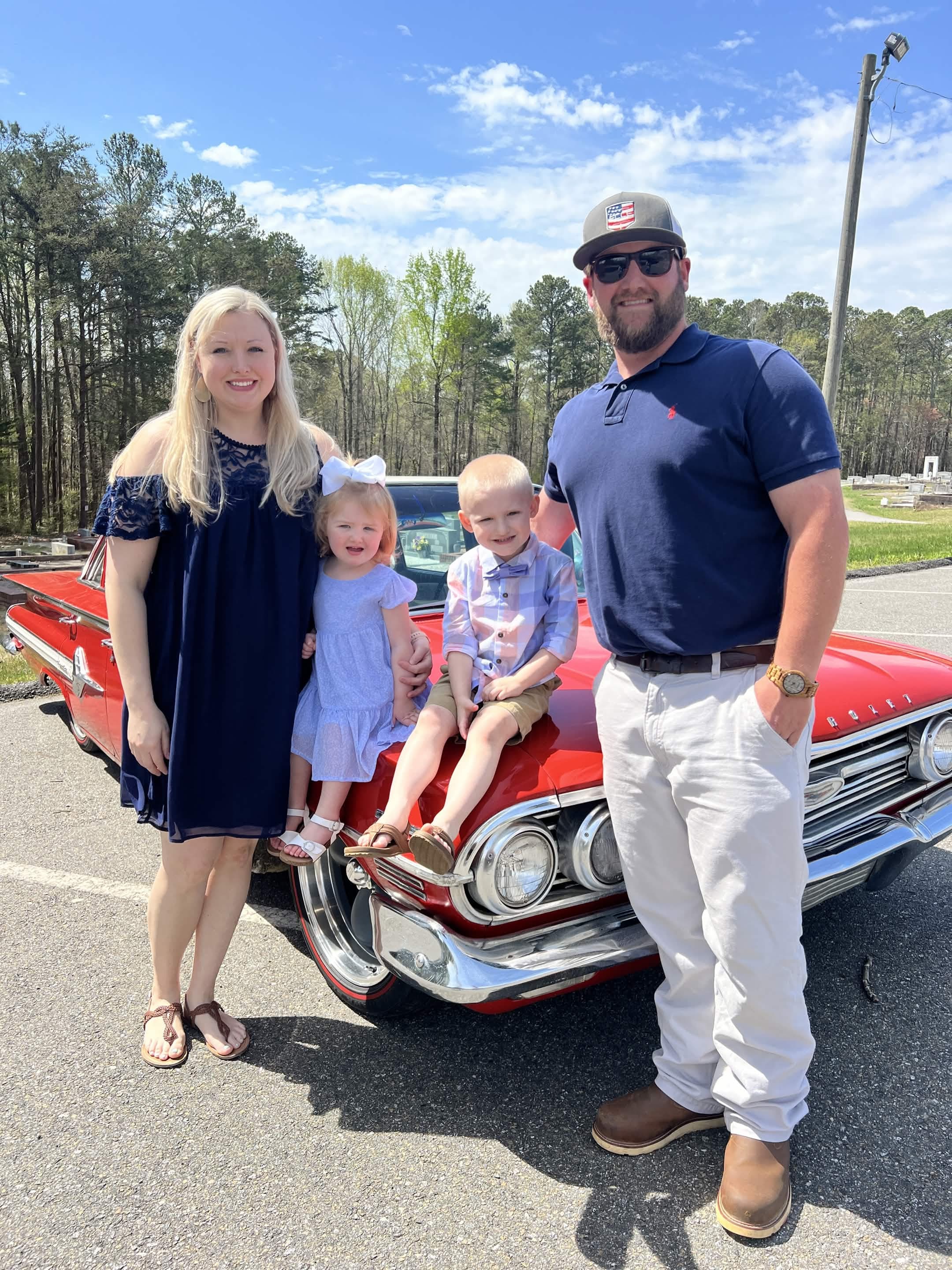 Trevor Evans, founder of Evans Custom Homes, with his wife and two children